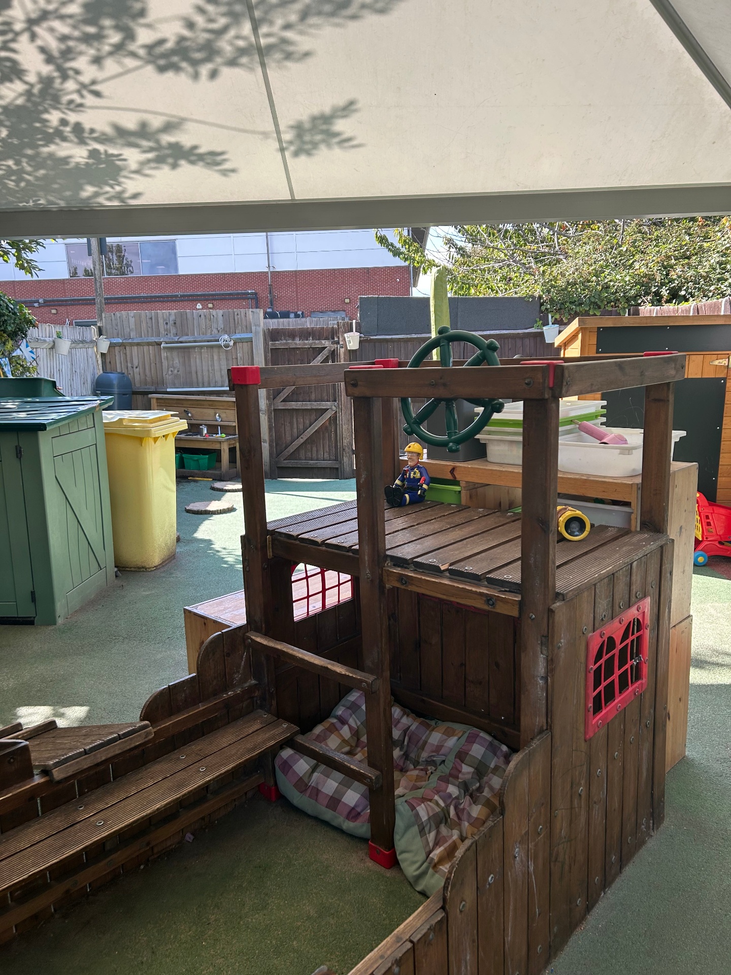 Our spacious garden with all-weather play surfaces and outdoor resources